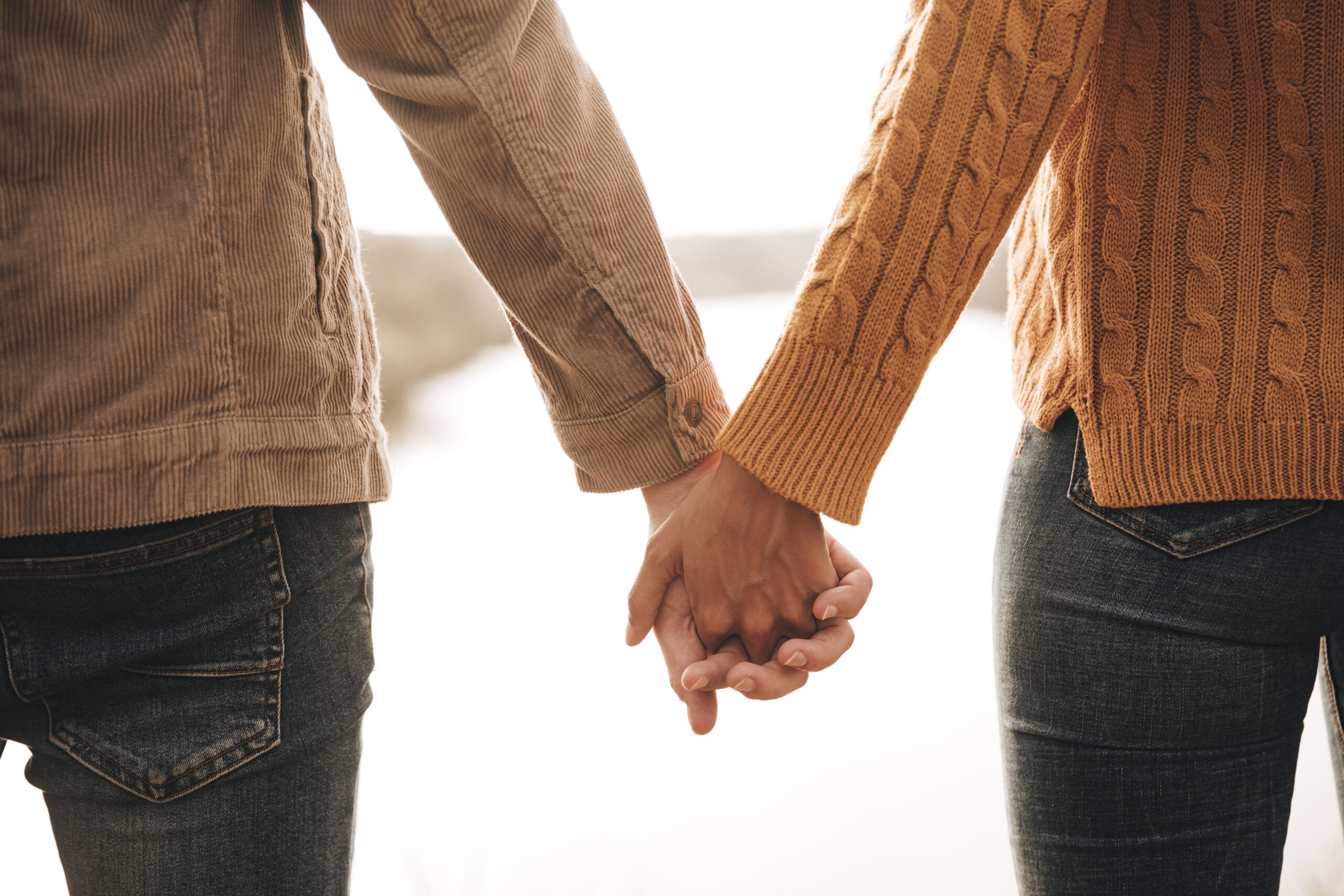 back view couple holding hands